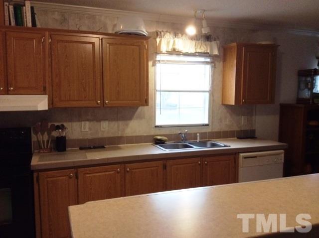 985 Mitchell Road Angier, NC 27501 - Photo 6 of 18 a kitchen with a sink a window and cabinets
