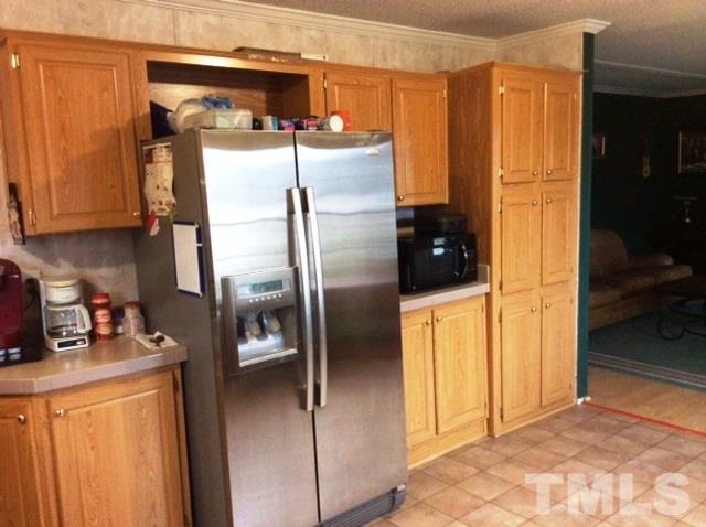 985 Mitchell Road Angier, NC 27501 - Photo 7 of 18 a kitchen with stainless steel appliances granite countertop a refrigerator a washer and dryer