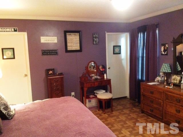 985 Mitchell Road Angier, NC 27501 - Photo 9 of 18 a bedroom with a bed and a dresser in it