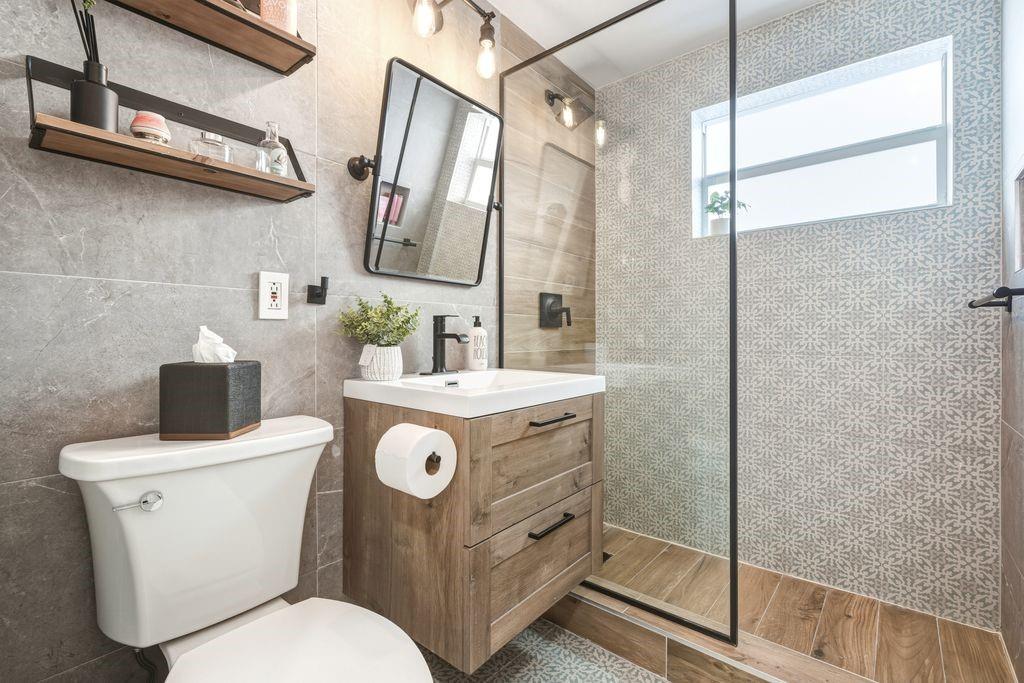 315 Van Buren Street, Unit 106B Hollywood, FL 33019 - Photo 6 of 14 Large step in shower with glass shower door