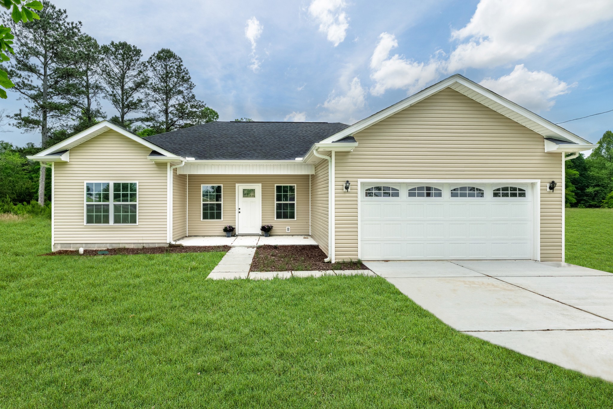 a front view of a house with a yard and porch