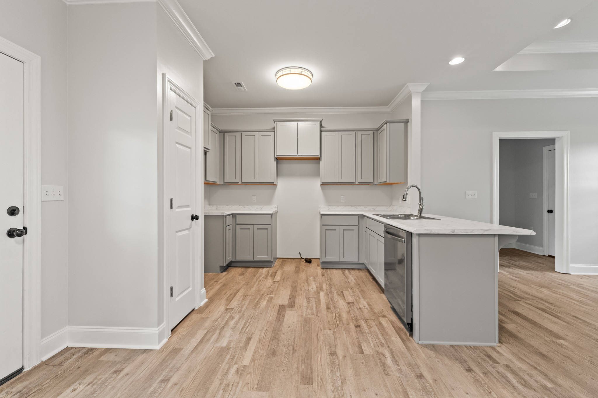 23101 Austin Whitt Road Ardmore, TN 38449 - Photo 17 of 35 a kitchen with a sink cabinets stainless steel appliances and wooden floor