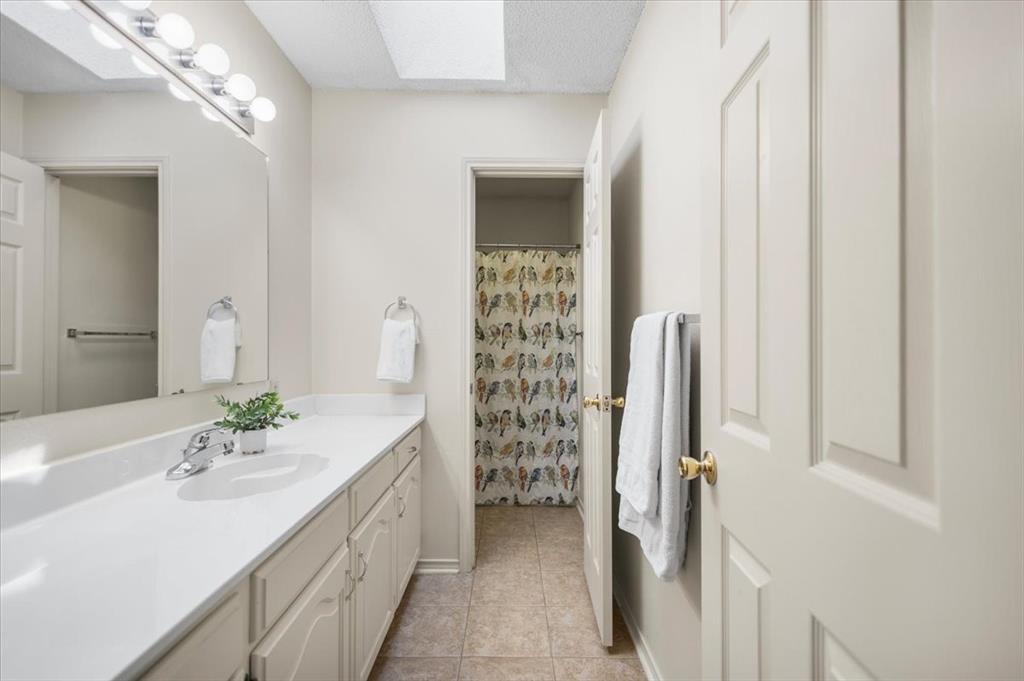 2824 Crestview Avenue Tyler, TX 75701 - Photo 20 of 39 a bathroom with a double vanity sink and a mirror