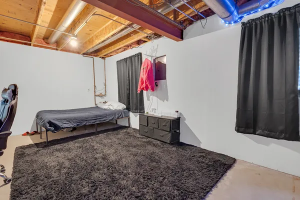 a bedroom with a bed and a couch