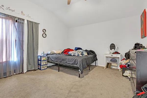 a bedroom with bed and a window