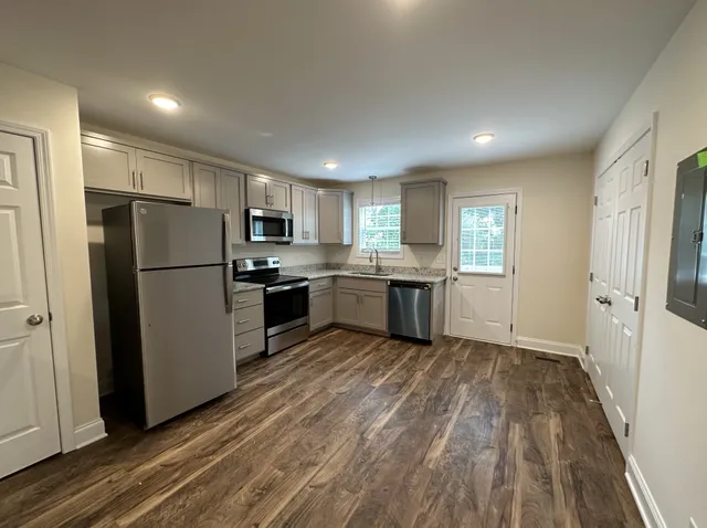a kitchen with a refrigerator a sink and cabinets