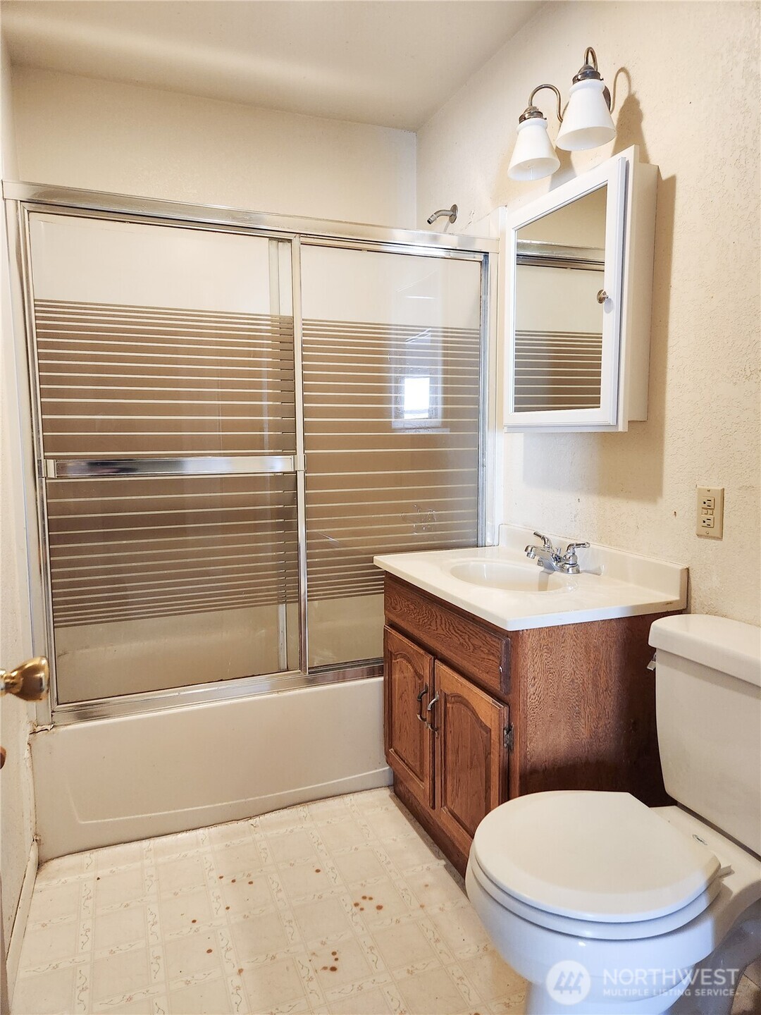 107 West 9th Avenue Ritzville, WA 99169 - Photo 17 of 26 a bathroom with a granite countertop sink toilet and shower