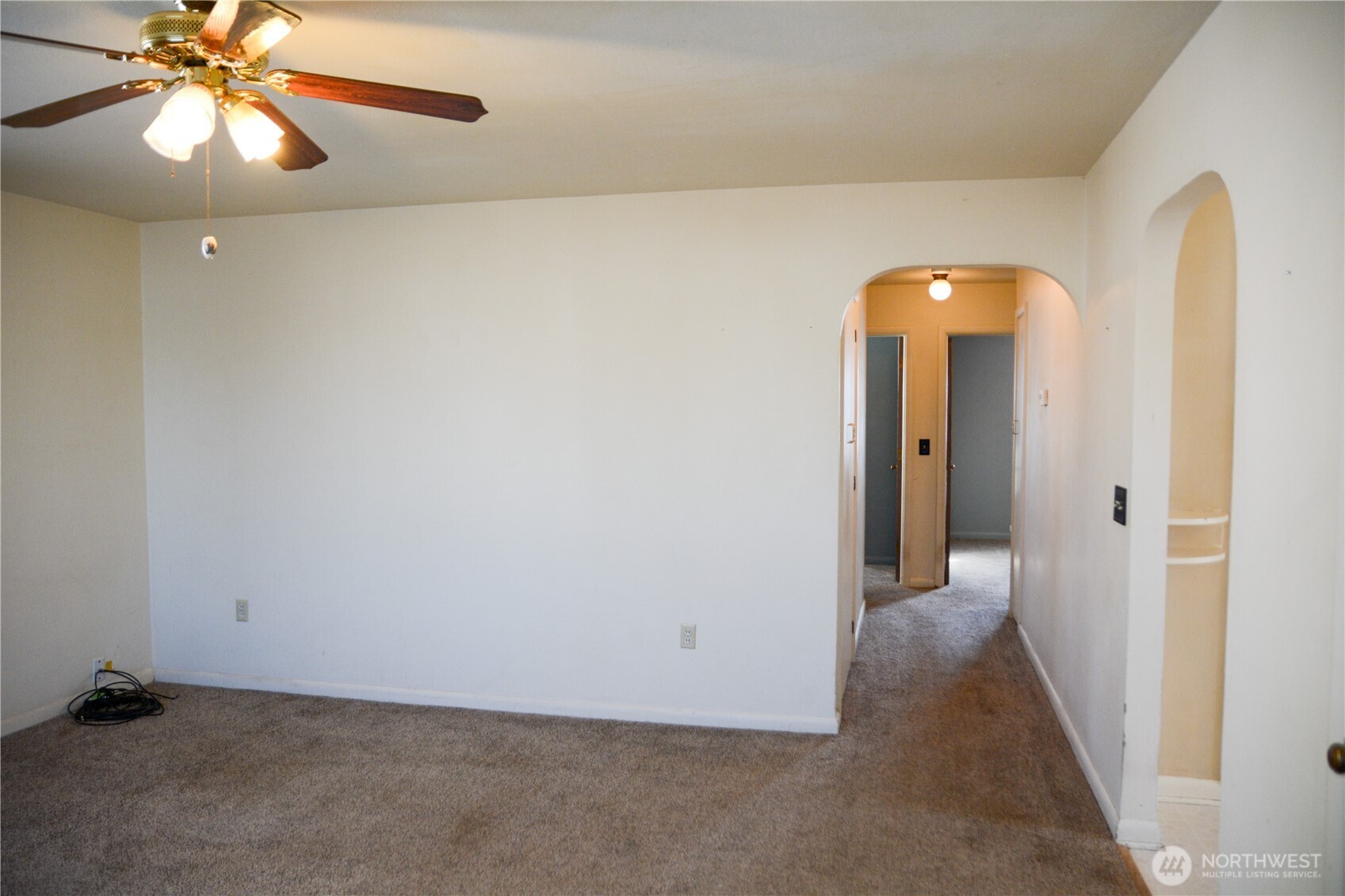 107 West 9th Avenue Ritzville, WA 99169 - Photo 3 of 26 an empty room with a hallway and a chandelier fan