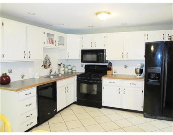 8 Fredrickson Road Billerica, MA 01821 - Photo 6 of 16 a kitchen with white cabinets and appliances