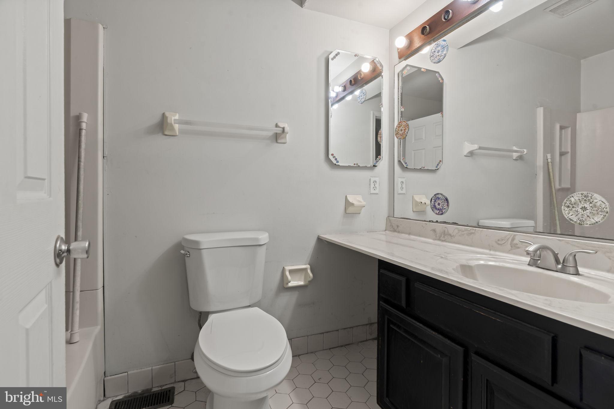 6500 Ditman Street Philadelphia, PA 19135 - Photo 19 of 30 a bathroom with a toilet sink and mirror