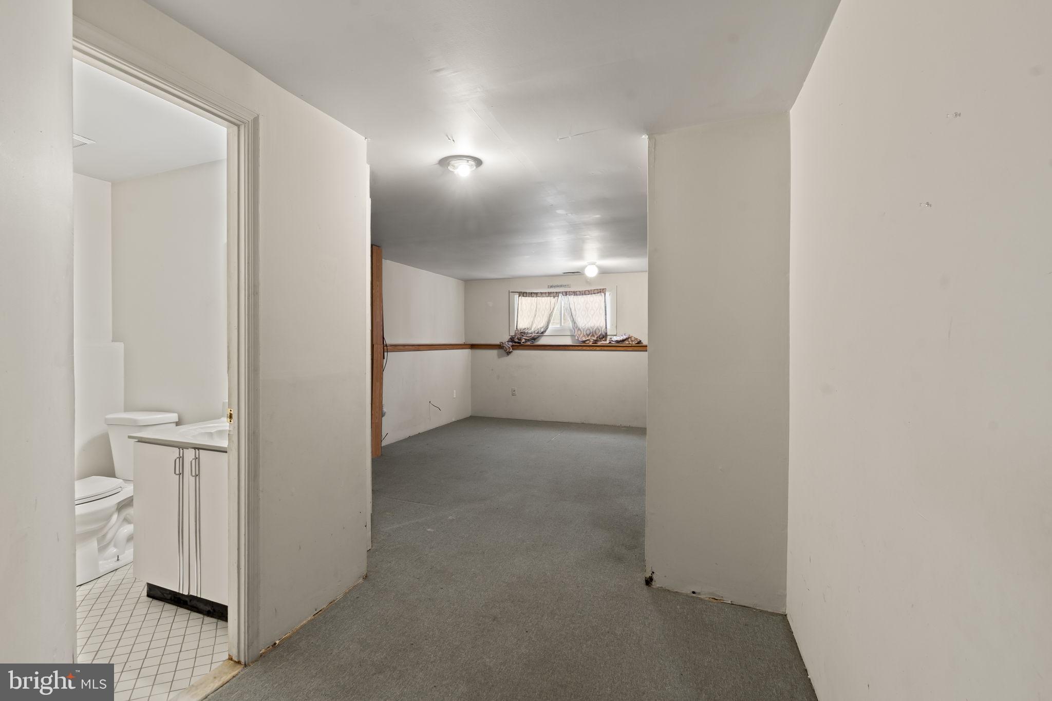 6500 Ditman Street Philadelphia, PA 19135 - Photo 24 of 30 a view of a hallway with an empty room and wooden floor