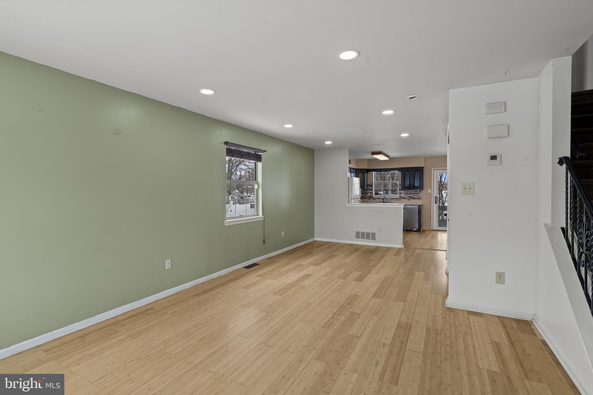 6500 Ditman Street Philadelphia, PA 19135 - Photo 3 of 30 an empty room with wooden floor and a kitchen