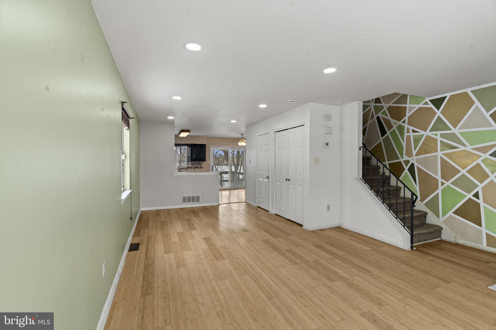 6500 Ditman Street Philadelphia, PA 19135 - Photo 4 of 30 an empty room with wooden floor and a kitchen