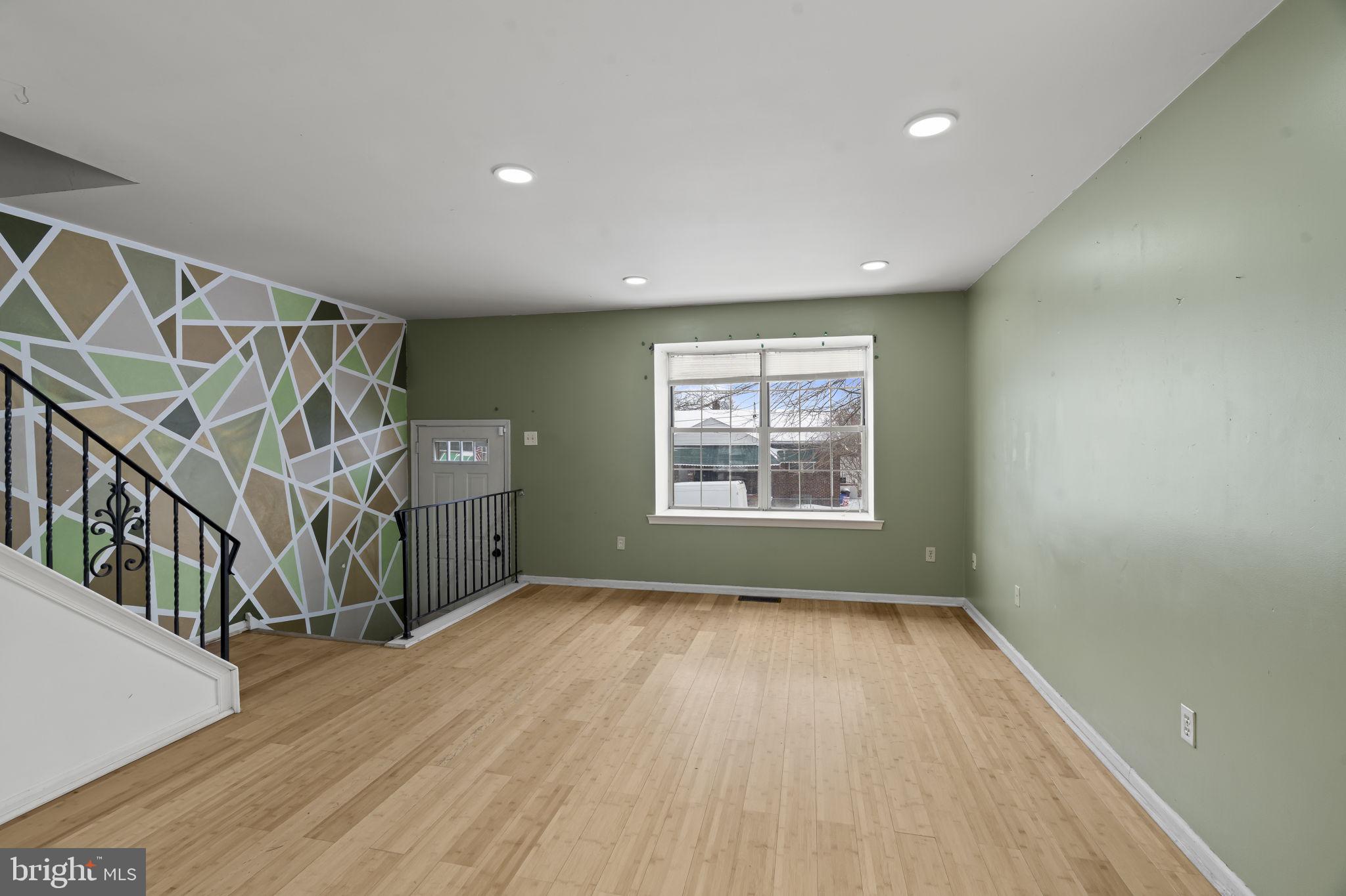 6500 Ditman Street Philadelphia, PA 19135 - Photo 6 of 30 a view of an empty room with wooden floor and a window