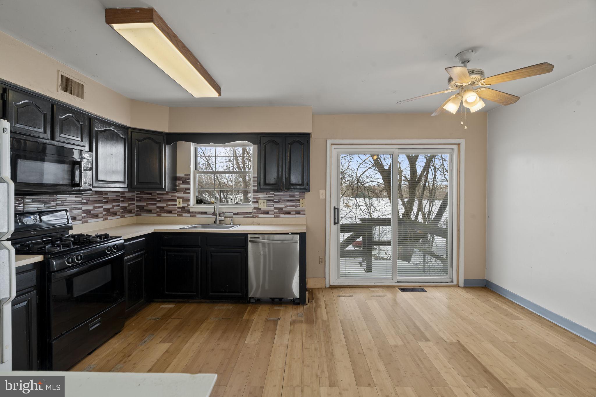 6500 Ditman Street Philadelphia, PA 19135 - Photo 8 of 30 a kitchen with stainless steel appliances granite countertop a stove cabinets and wooden floor