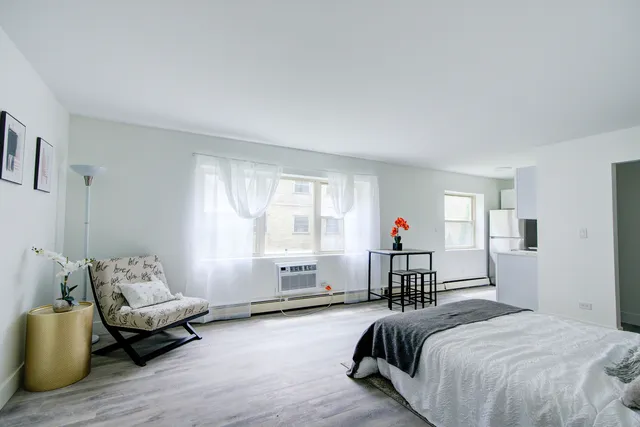 a spacious bedroom with a bed and a couch