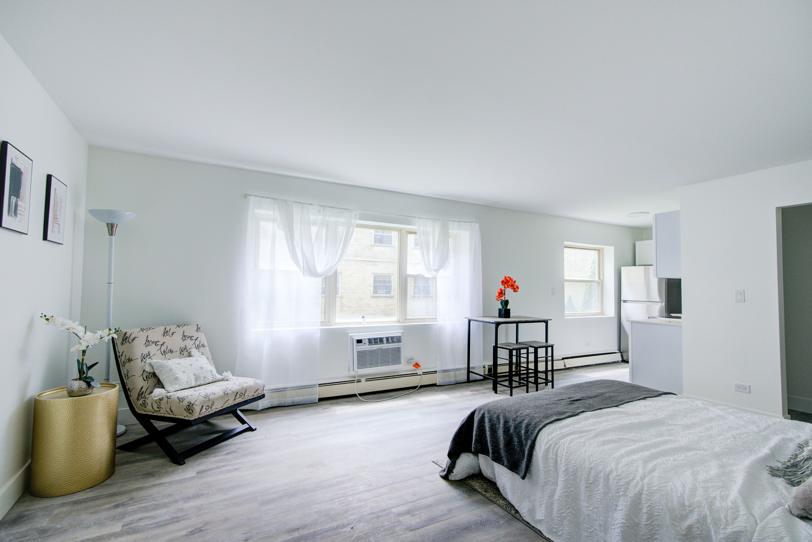 7250 North Western Avenue, Unit 306 Chicago, IL 60645 - Photo 11 of 17 a spacious bedroom with a bed and a couch