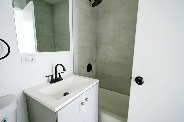 a bathroom with a sink a mirror and shower