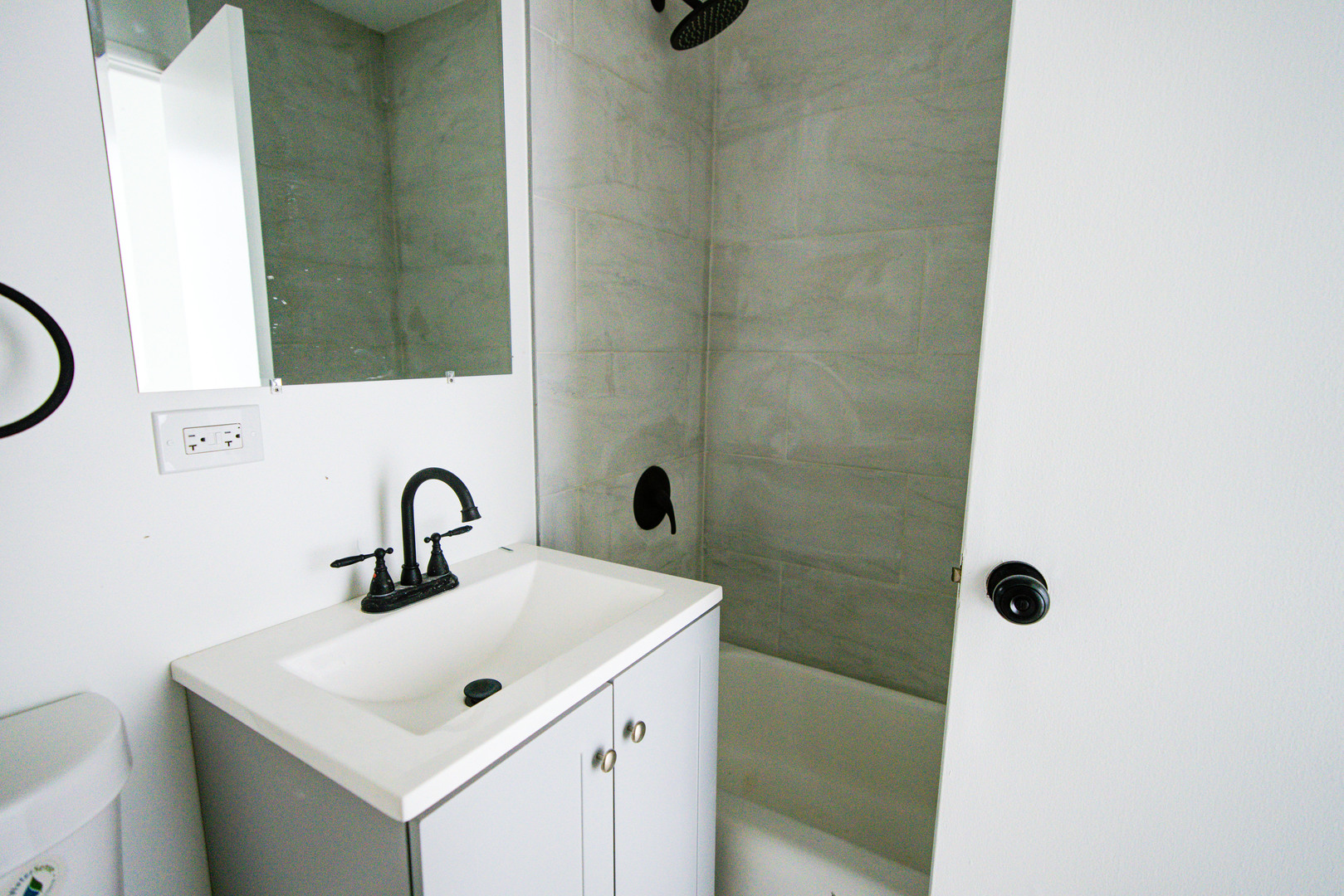 7250 North Western Avenue, Unit 306 Chicago, IL 60645 - Photo 17 of 17 a bathroom with a sink a mirror and shower