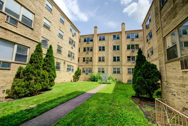 a view of a building with a yard
