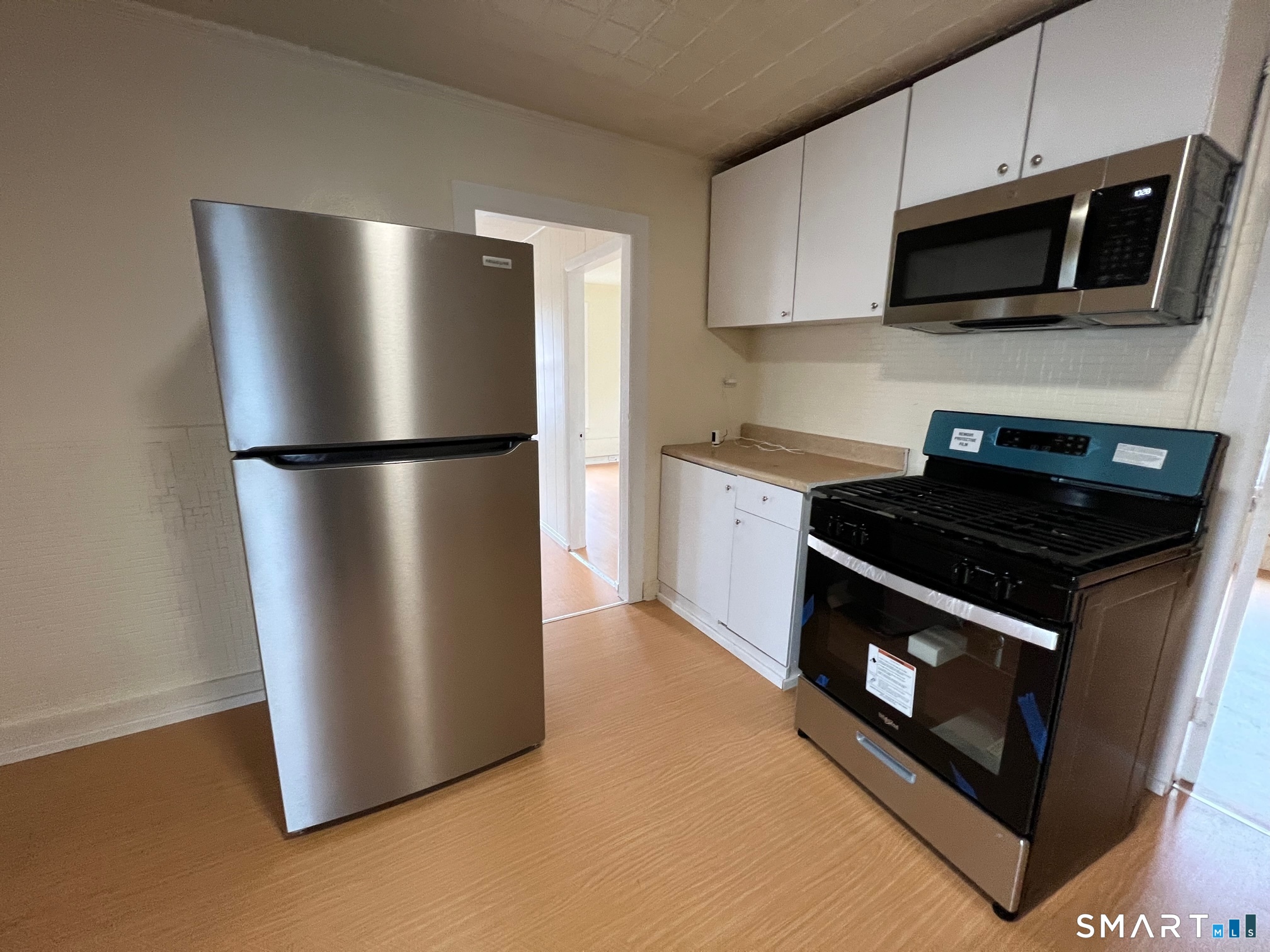 62 North Leonard Street Waterbury, CT 06708 - Photo 7 of 13 a kitchen with a stainless steel appliances and cabinets
