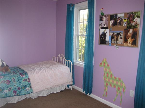 11 Comstock Place Rochester, MA 02770 - Photo 17 of 21 a bed room with a bed and a painting on the wall