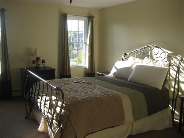 11 Comstock Place Rochester, MA 02770 - Photo 19 of 21 a bed sitting in a bedroom next to a window
