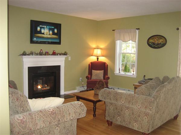 11 Comstock Place Rochester, MA 02770 - Photo 5 of 21 a living room with furniture a fireplace and a window