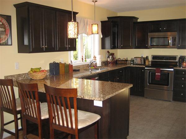 11 Comstock Place Rochester, MA 02770 - Photo 6 of 21 a kitchen with a kitchen island hardwood floor sink stove dining table and chairs