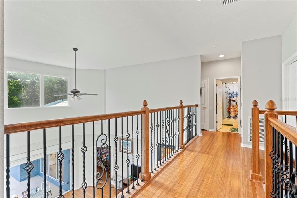 12833 Darby Ridge Drive Tampa, FL 33624 - Photo 30 of 33 a view of a hallway with wooden floor and stairs