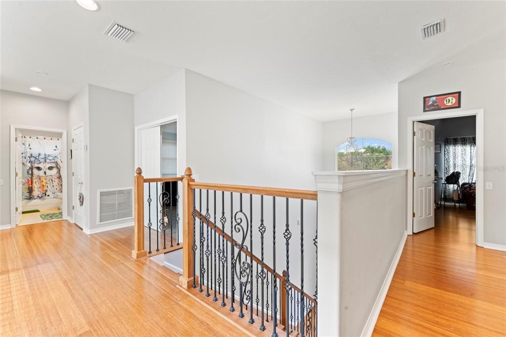 12833 Darby Ridge Drive Tampa, FL 33624 - Photo 8 of 33 a view of a hallway with wooden floor and furniture