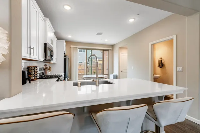 a kitchen with a dining table chairs and window