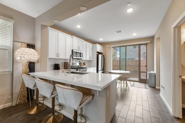a view of kitchen with cabinets table and chairs