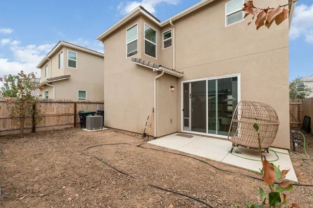 a view of a house with backyard and sitting area