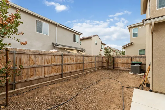 a view of a house with wooden fence
