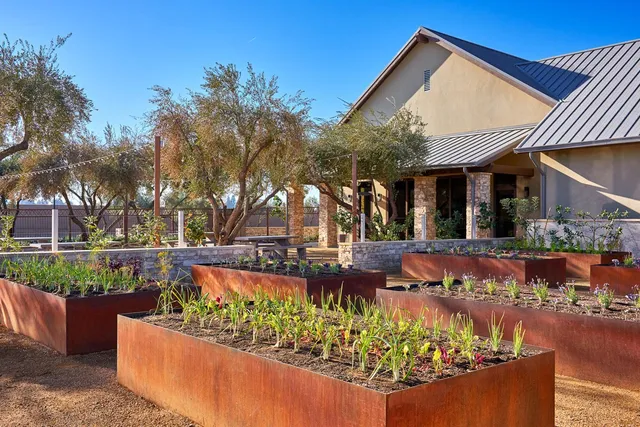 a view of a white house with a yard and sitting area