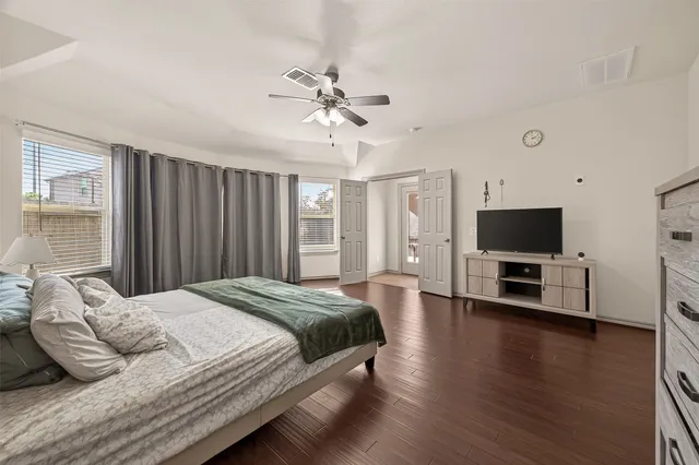 a bedroom with a bed and a flat screen tv