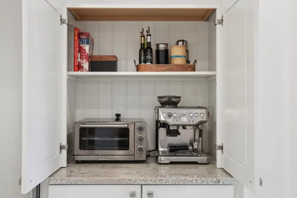 a kitchen with stainless steel appliances kitchen island granite countertop a stove and a sink