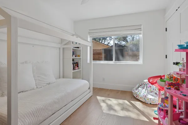 a bedroom with a large bed and a painting on the wall