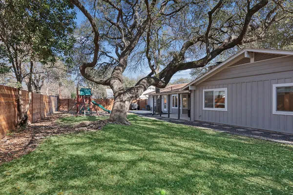 a view of a house with backyard porch and sitting area