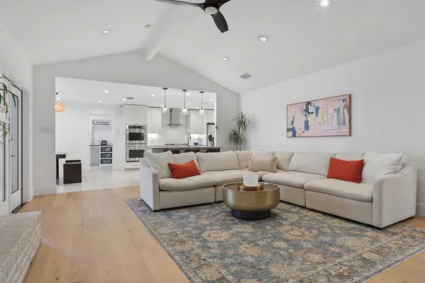 a living room with furniture and kitchen view