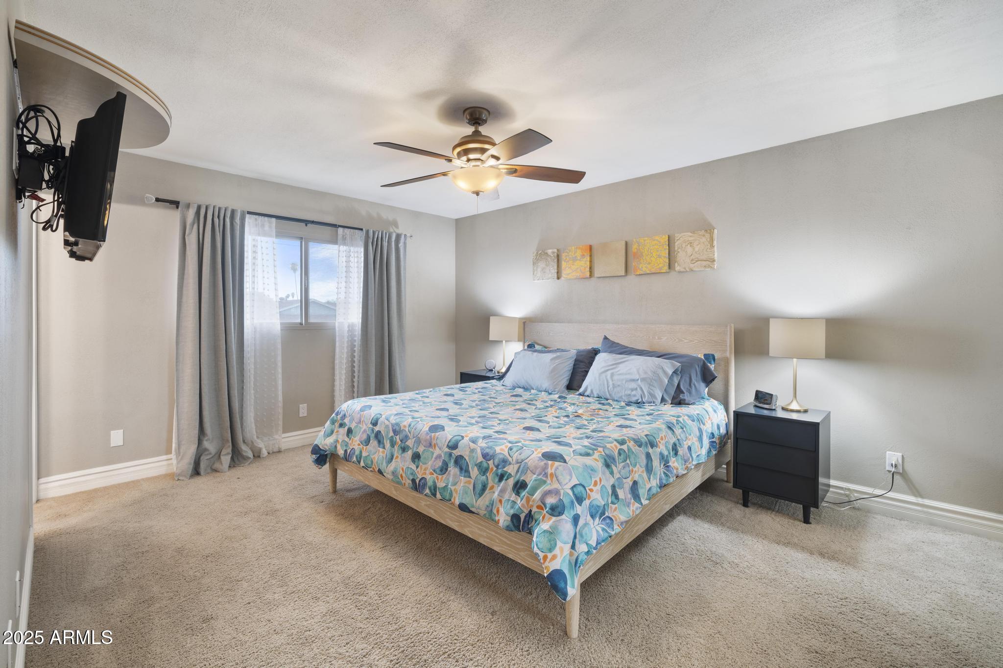 3912 South Elm Street Tempe, AZ 85282 - Photo 17 of 33 a bedroom with a bed and a chandelier