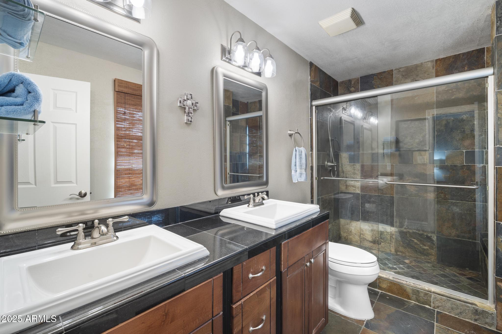 3912 South Elm Street Tempe, AZ 85282 - Photo 18 of 33 a bathroom with a sink vanity granite toilet and a mirror