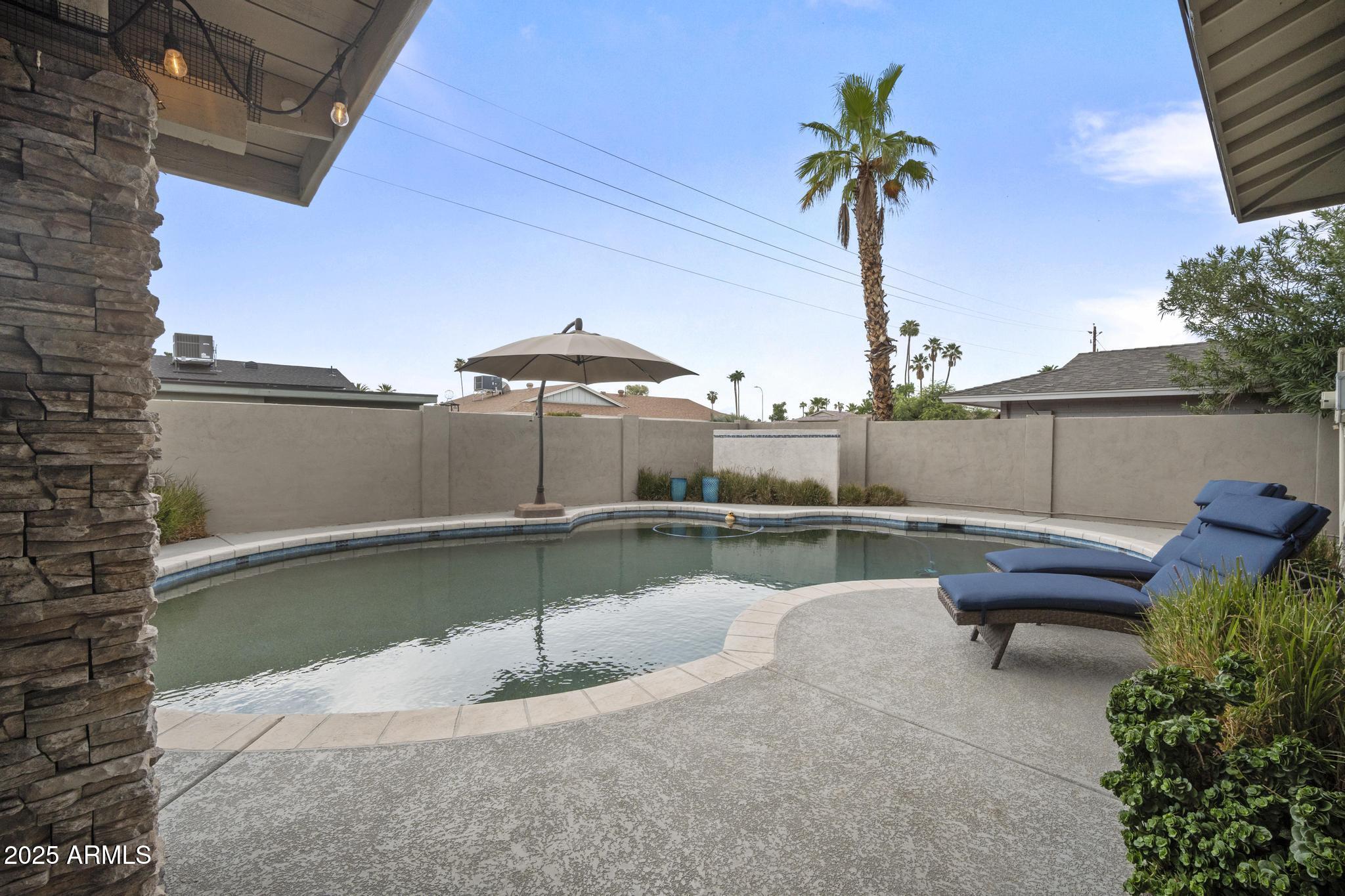 3912 South Elm Street Tempe, AZ 85282 - Photo 24 of 33 a view of a swimming pool with a lounge chairs