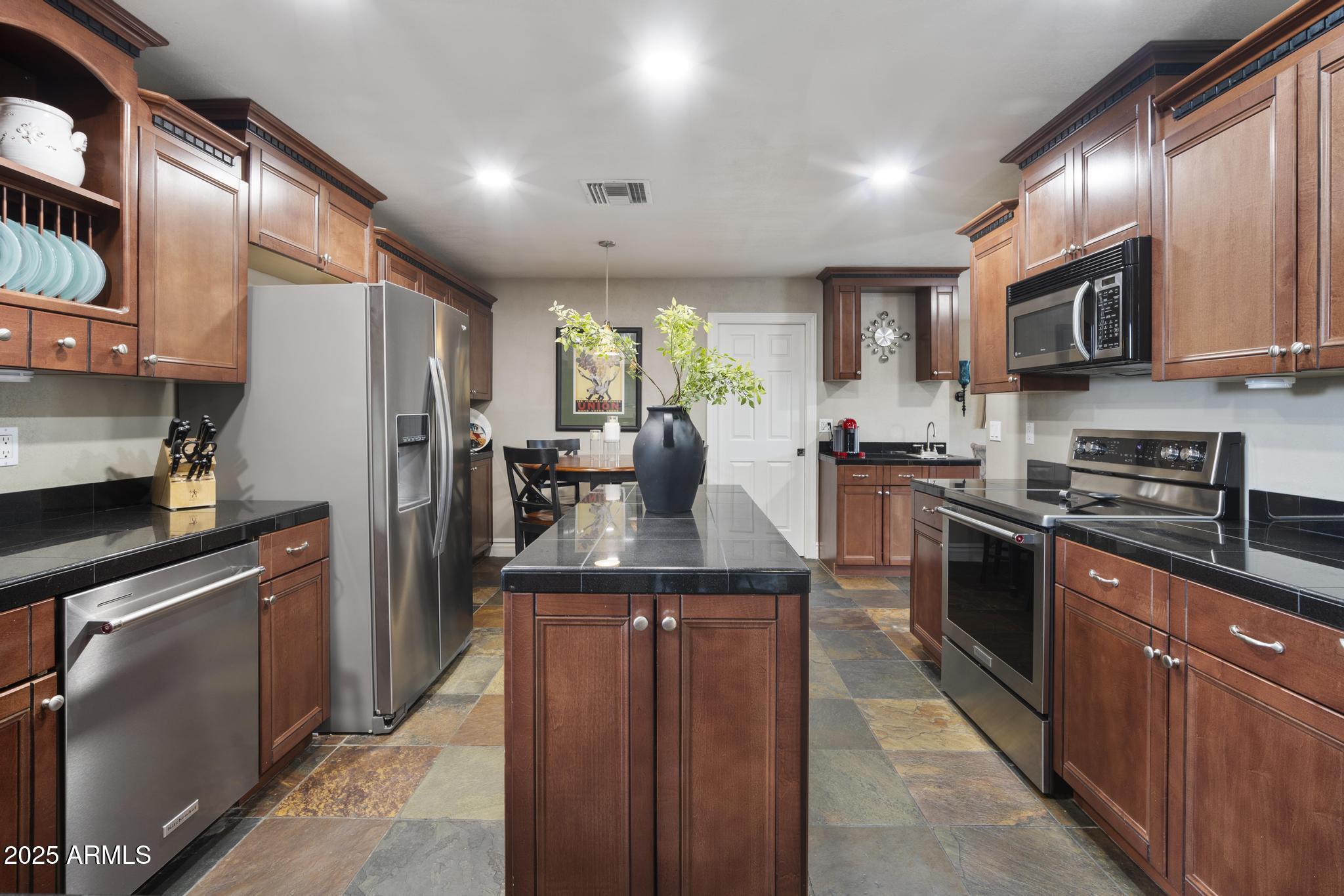 3912 South Elm Street Tempe, AZ 85282 - Photo 5 of 33 a kitchen with stainless steel appliances granite countertop a refrigerator and a stove