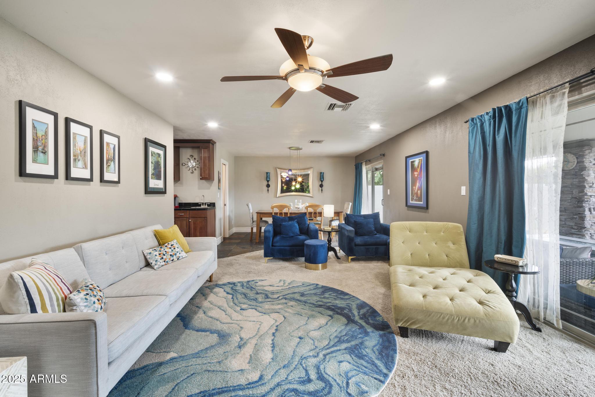 3912 South Elm Street Tempe, AZ 85282 - Photo 8 of 33 a living room with furniture ceiling fan and a rug
