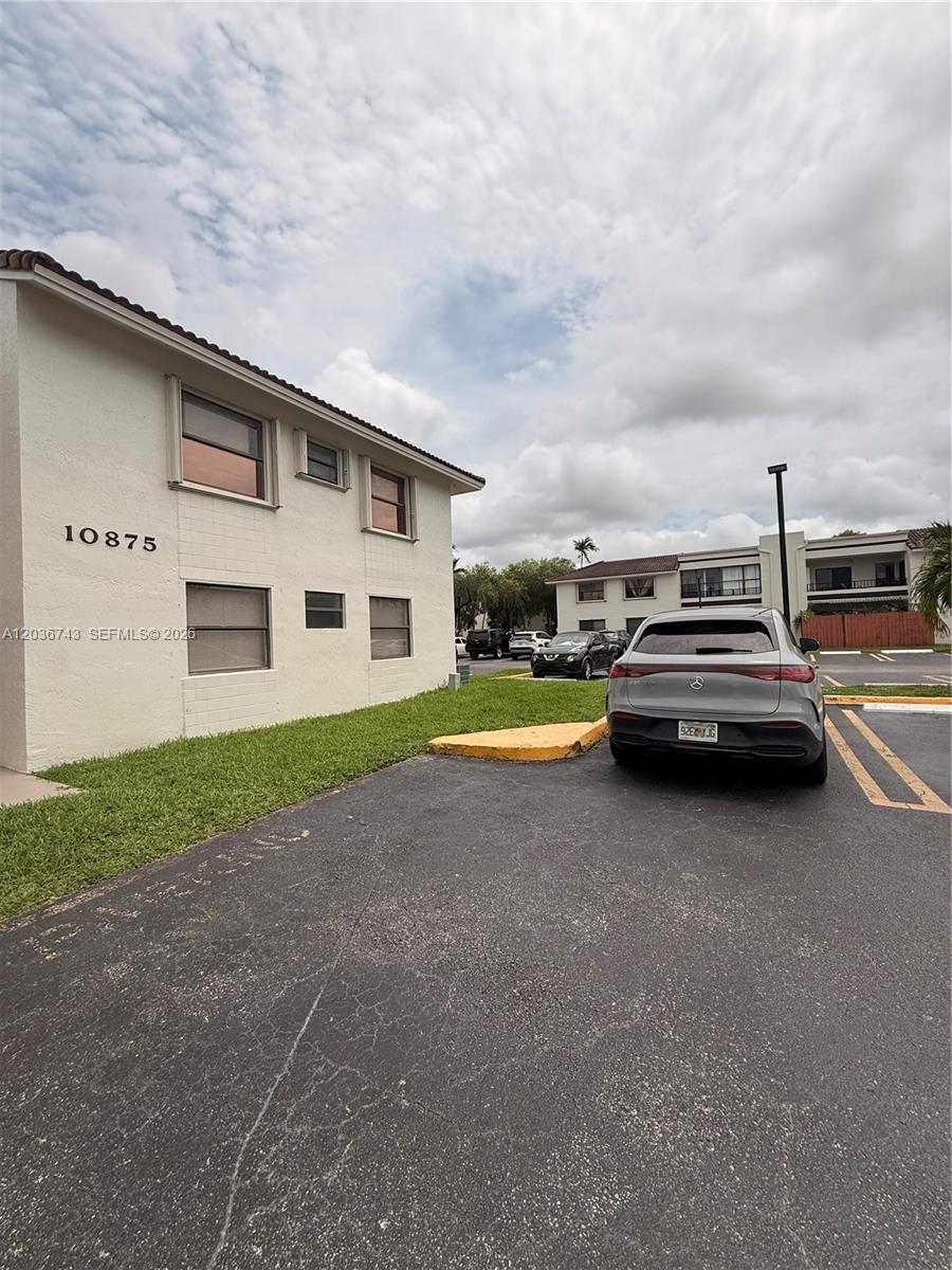 10875 Northwest 7th Street, Unit 1136 Miami, FL 33172 - Photo 25 of 25 a view of a car parked in front of a house