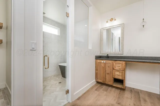 a bathroom with a granite countertop sink a toilet and a mirror