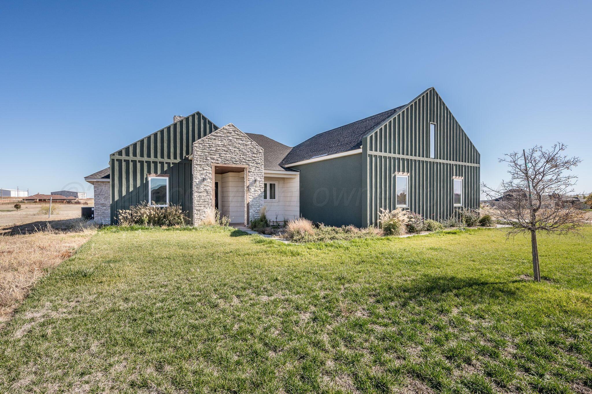 13351 Genevieve's Way Amarillo, TX 79118 - Photo 2 of 35 a front view of a house with garden