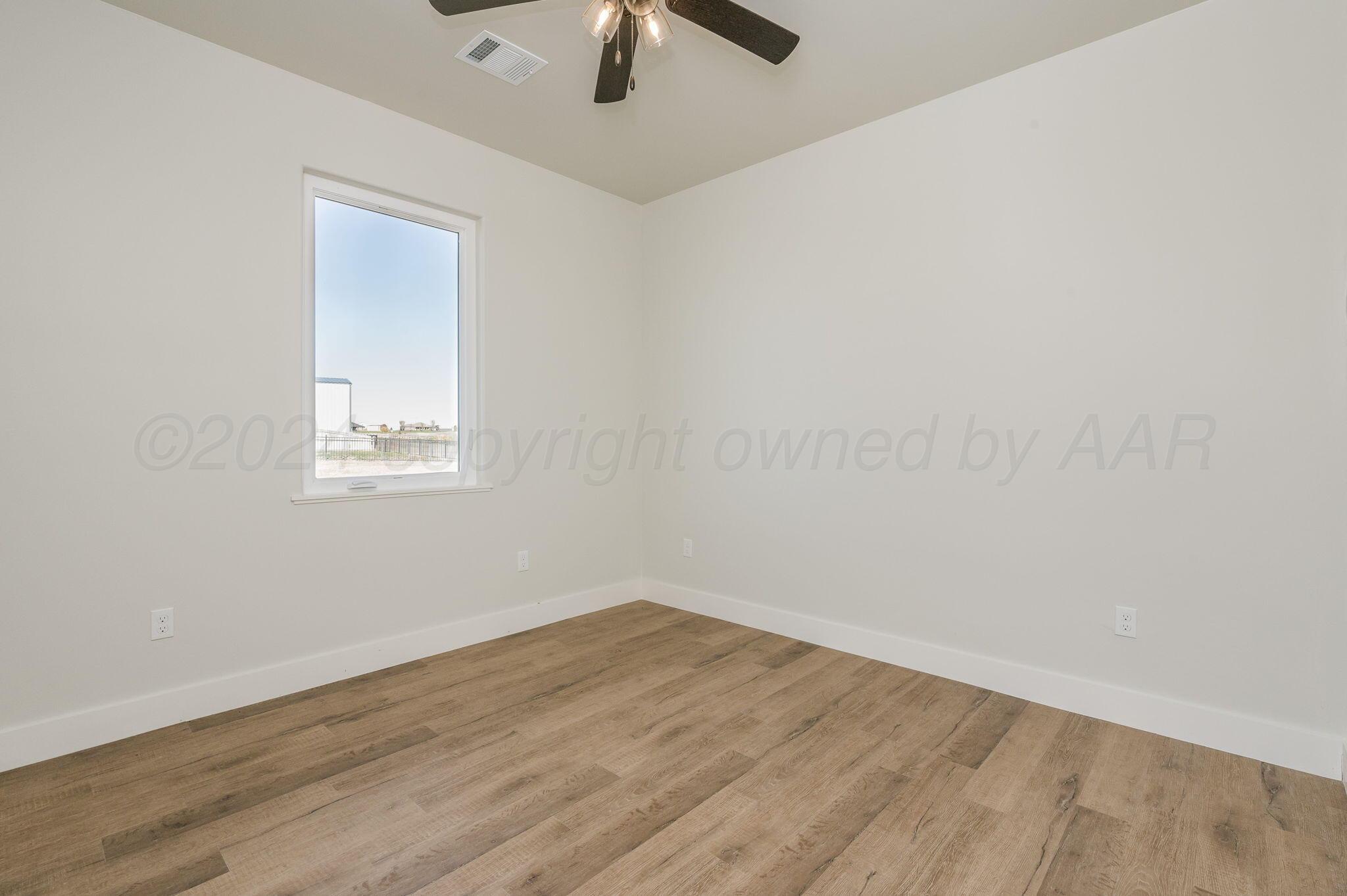 13351 Genevieve's Way Amarillo, TX 79118 - Photo 22 of 35 an empty room with a window and a ceiling fan